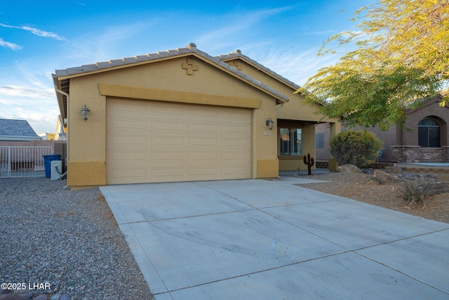 ranch-style house with a garage, fence, driveway, a tiled roof, and stucco siding