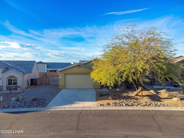 view of front of home with an attached garage, concrete driveway, and stucco siding