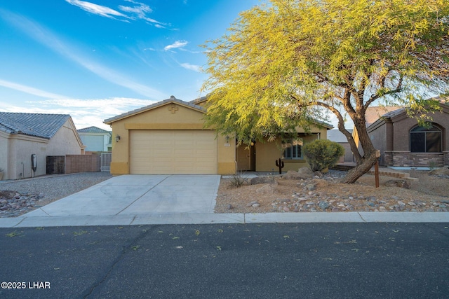 view of front of home with a garage, concrete driveway, and stucco siding