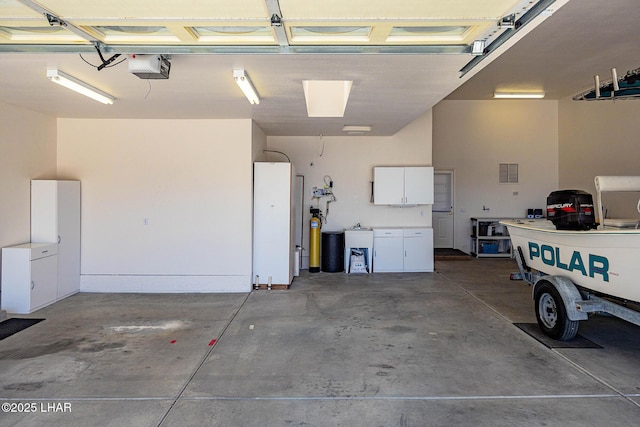 garage with visible vents and a garage door opener