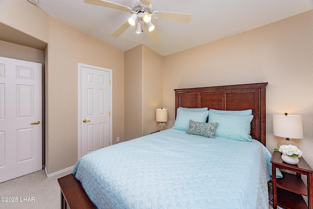 bedroom featuring a ceiling fan, light carpet, and baseboards