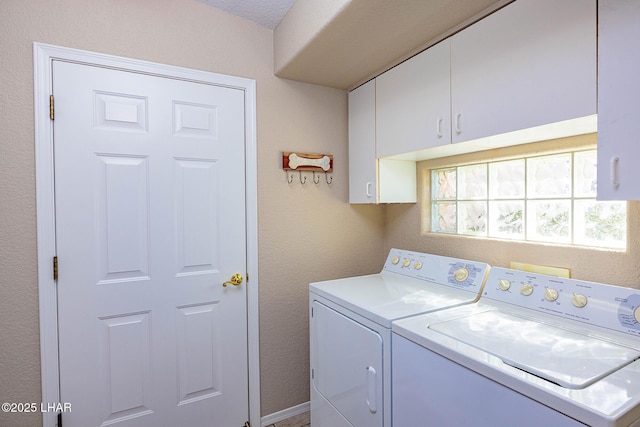 clothes washing area with independent washer and dryer and cabinet space