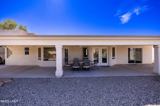 rear view of property featuring french doors, a patio area, and stucco siding