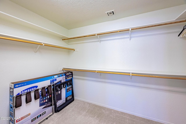 walk in closet with carpet and visible vents