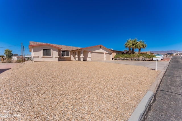 ranch-style home featuring stucco siding