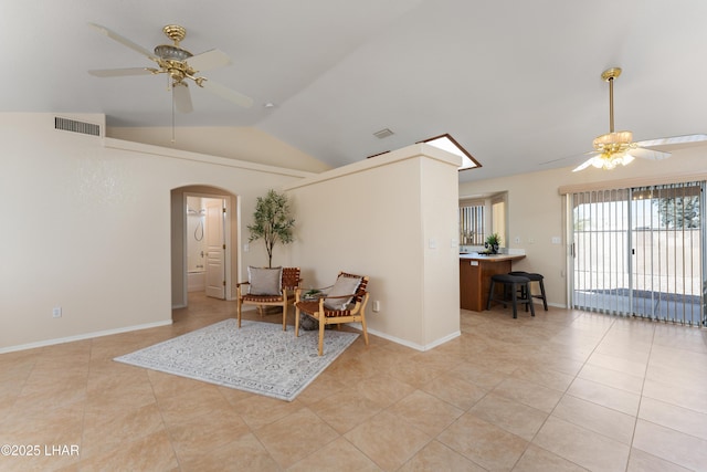 sitting room with visible vents, ceiling fan, baseboards, lofted ceiling, and arched walkways