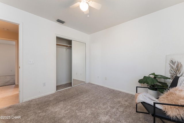 unfurnished bedroom featuring visible vents, baseboards, ceiling fan, carpet flooring, and a closet