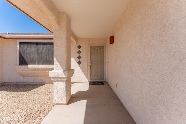 property entrance with stucco siding