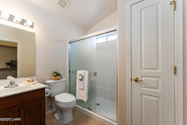 bathroom with visible vents, toilet, a shower stall, tile patterned flooring, and vanity