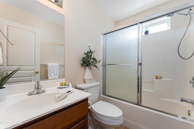 full bath featuring enclosed tub / shower combo, toilet, and vanity