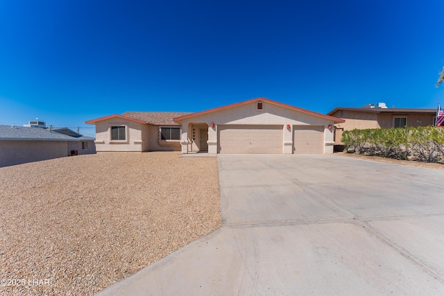 ranch-style home featuring stucco siding, an attached garage, and driveway