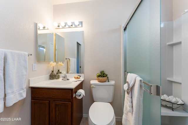 bathroom with a shower with door, toilet, and vanity