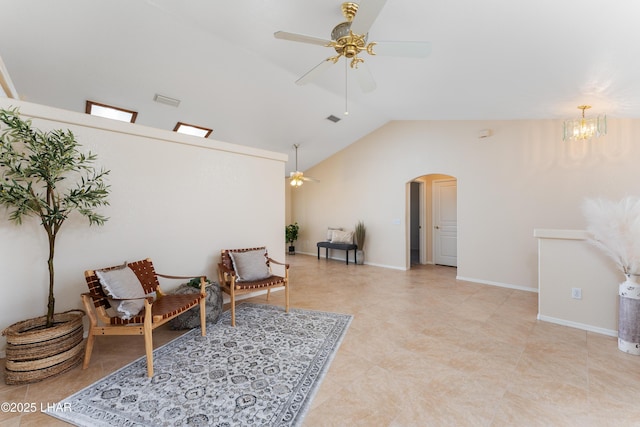 living area with visible vents, baseboards, lofted ceiling, arched walkways, and ceiling fan with notable chandelier