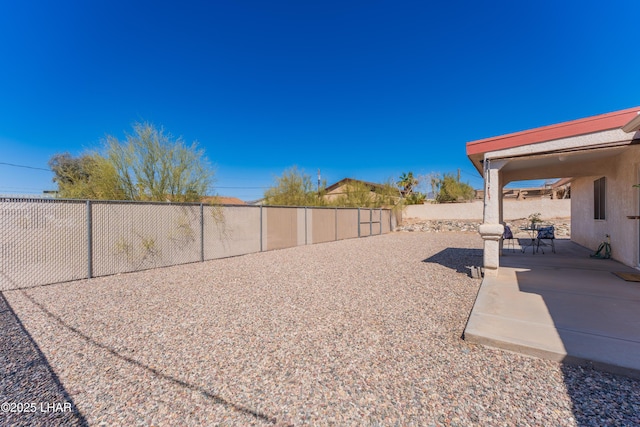 view of yard featuring a patio area and a fenced backyard