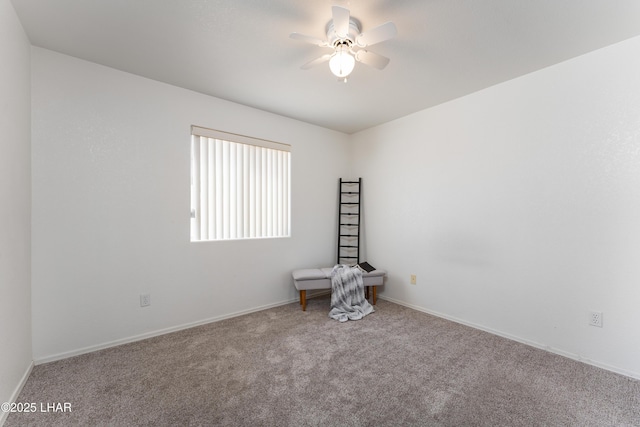 carpeted spare room with baseboards and ceiling fan