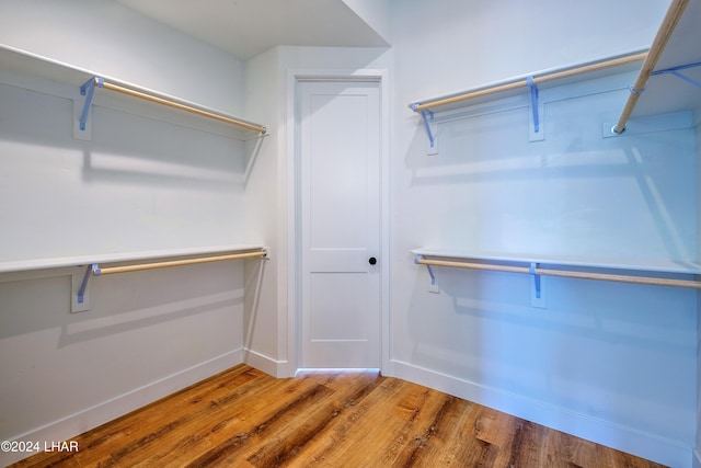 spacious closet with hardwood / wood-style floors