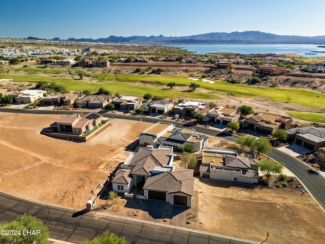 birds eye view of property with a water and mountain view