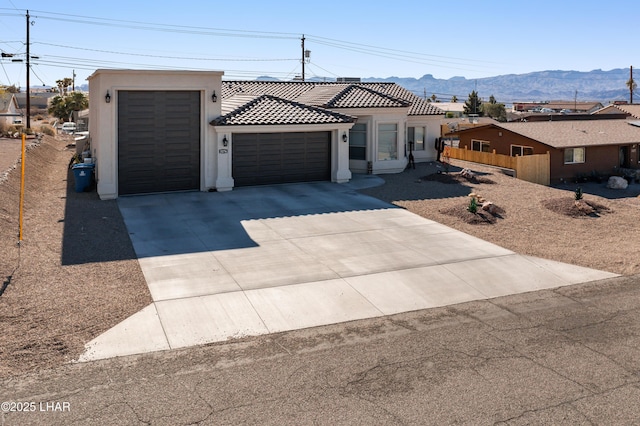 view of front of house with a mountain view and a garage