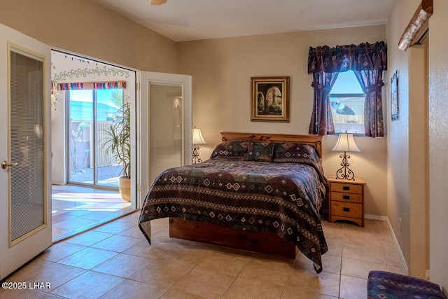 1972 E Bayshore Rd, Lake Havasu City, AZ 86404 - tiled bedroom featuring baseboards, multiple windows, and access to outside