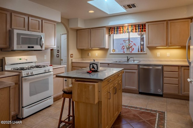 1972 E Bayshore Rd, Lake Havasu City, AZ 86404 - kitchen with light tile patterned floors, visible vents, a skylight, a sink, and stainless steel appliances