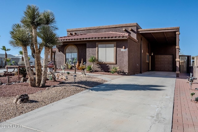 1972 E Bayshore Rd, Lake Havasu City, AZ 86404 - view of front of house with a tiled roof, an attached garage, driveway, and stucco siding