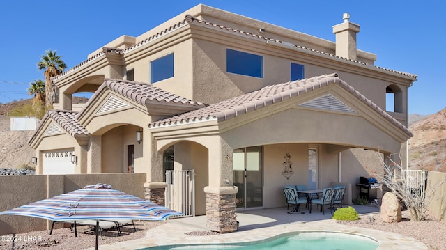 rear view of property featuring a patio