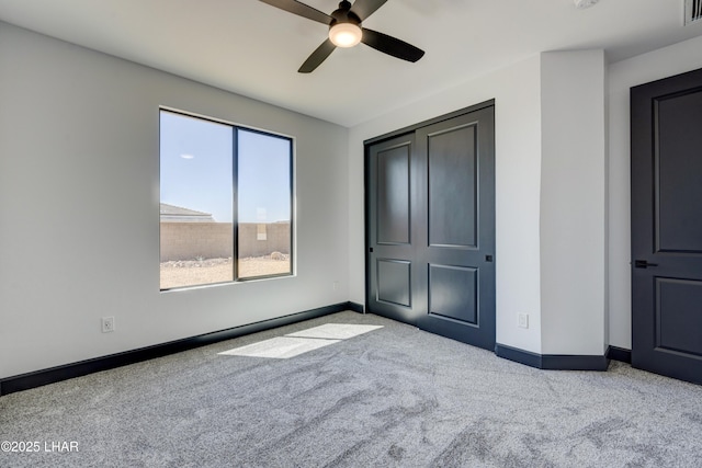 unfurnished bedroom with carpet, visible vents, ceiling fan, and baseboards