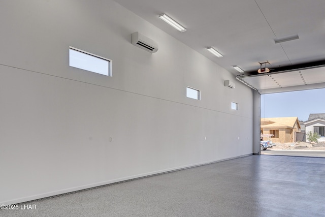 garage featuring a garage door opener, baseboards, and a wall mounted AC