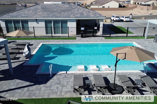 pool featuring fence and a patio