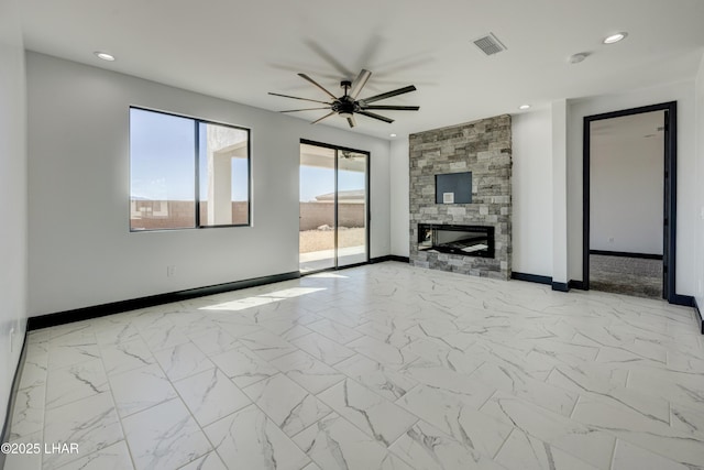 unfurnished living room with baseboards, visible vents, marble finish floor, a stone fireplace, and recessed lighting