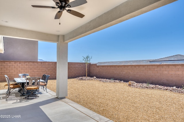 view of patio / terrace with outdoor dining area, a fenced backyard, and ceiling fan