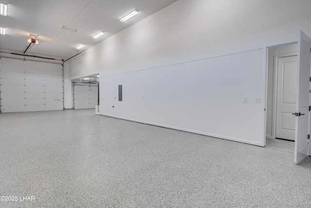 garage featuring electric panel and a garage door opener