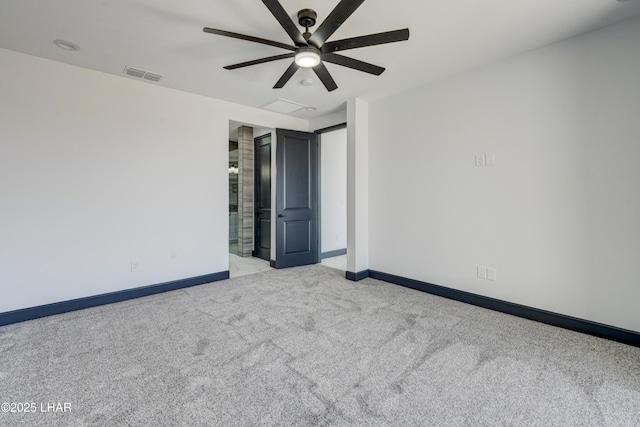 spare room with ceiling fan, carpet, visible vents, and baseboards