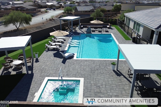 community pool featuring a gazebo, a patio area, a fenced backyard, and a residential view