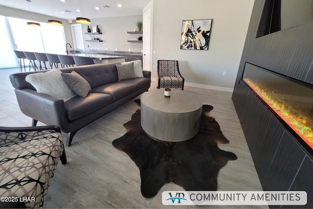 living room with recessed lighting and baseboards