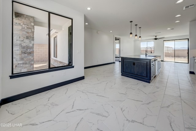 kitchen with a center island with sink, recessed lighting, visible vents, a sink, and baseboards