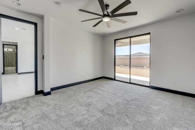 unfurnished room with carpet floors, a ceiling fan, and baseboards