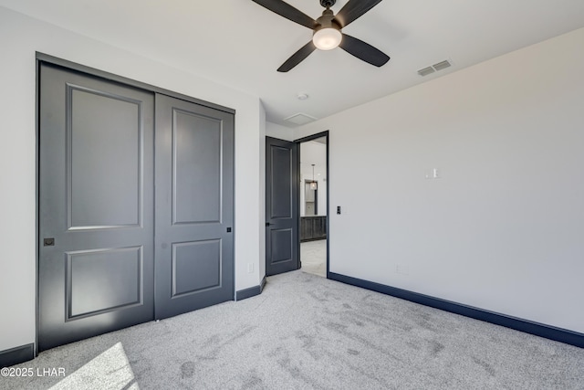 carpeted bedroom featuring a ceiling fan, a closet, visible vents, and baseboards