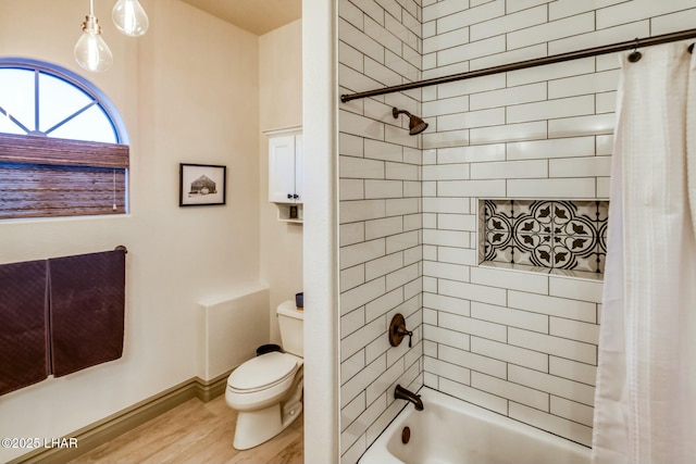 bathroom featuring wood-type flooring, shower / tub combo with curtain, and toilet