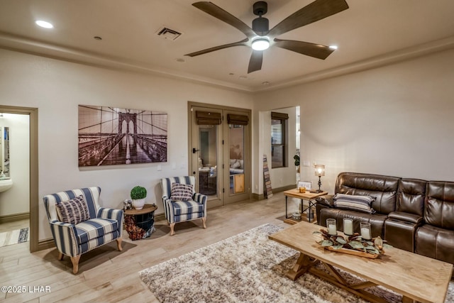 living room with light hardwood / wood-style floors and ceiling fan