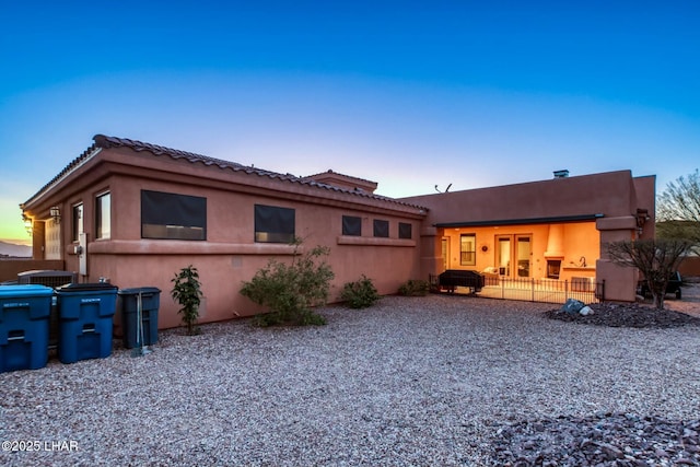 back house at dusk with a patio