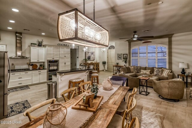 dining area featuring ceiling fan and light hardwood / wood-style flooring