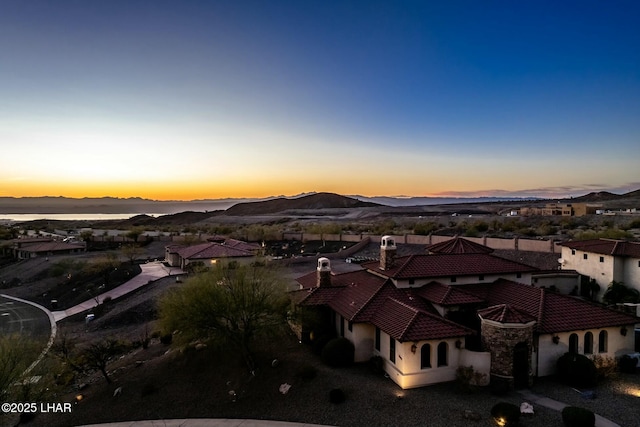 aerial view at dusk featuring a mountain view