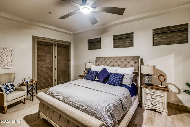 bedroom with light hardwood / wood-style floors and ceiling fan