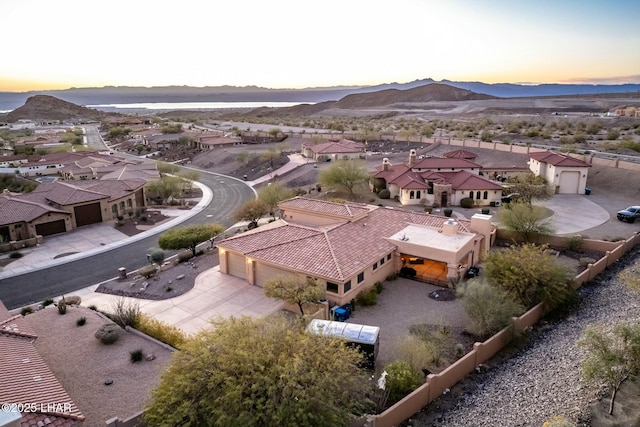 aerial view at dusk featuring a mountain view