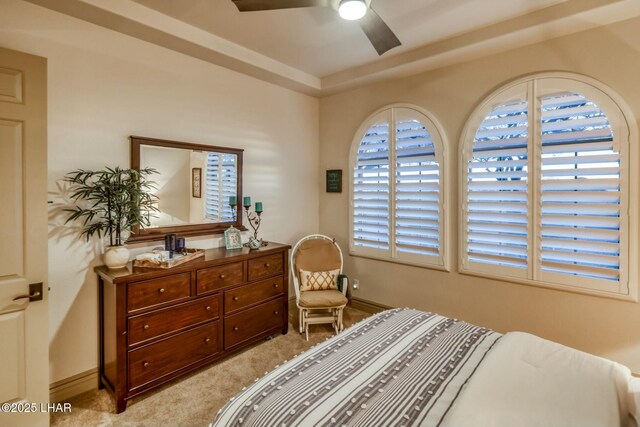 bedroom with ceiling fan and light carpet