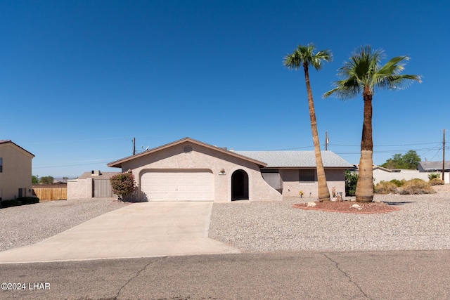 ranch-style home featuring a garage