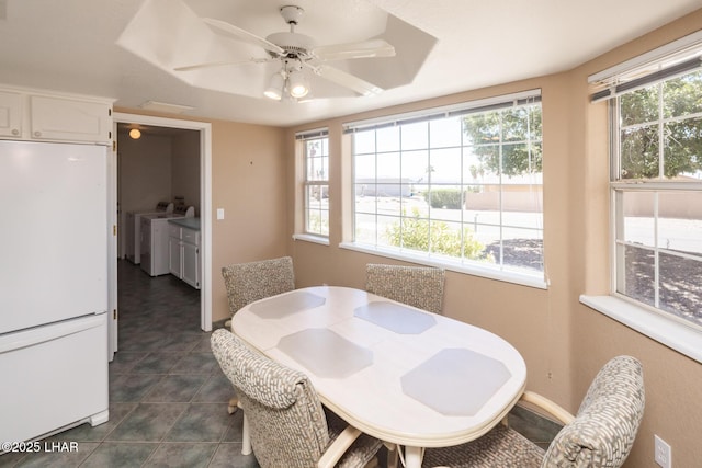 4080 Albacore Dr, Lake Havasu City, AZ 86406 - dining space with washing machine and dryer, a ceiling fan, and dark tile patterned flooring