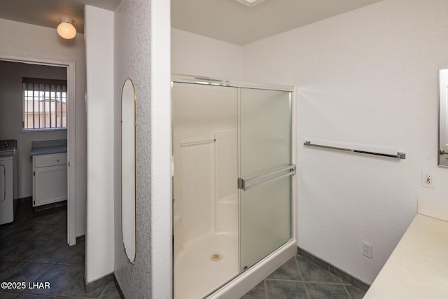 4080 Albacore Dr, Lake Havasu City, AZ 86406 - bathroom with a stall shower, washer / dryer, tile patterned flooring, and vanity