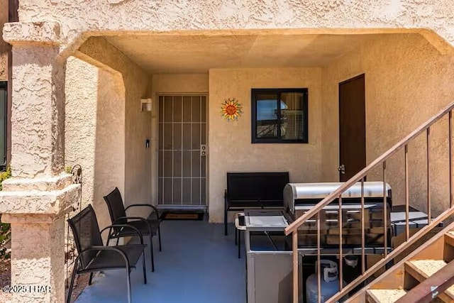 entrance to property featuring a patio